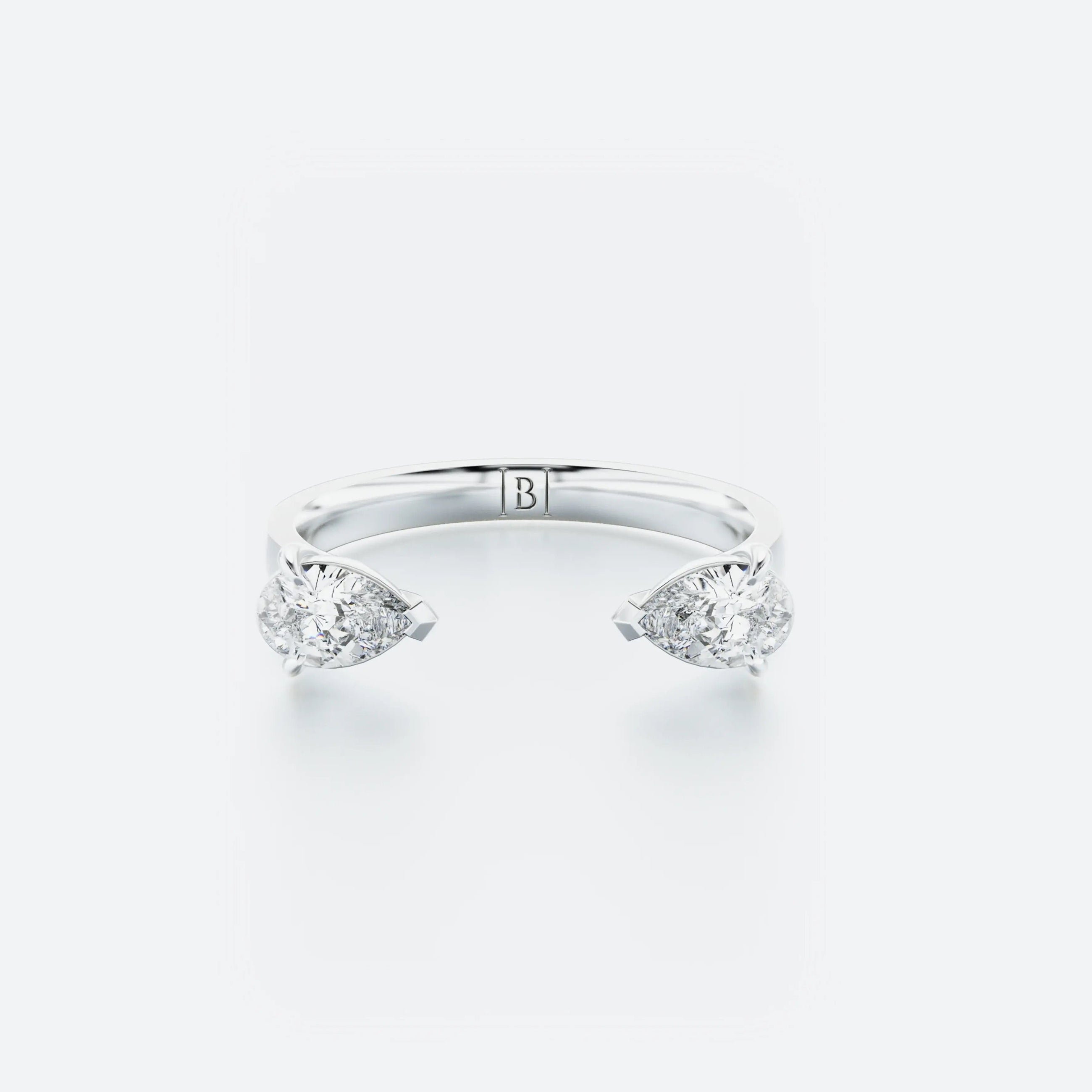 Pear-Shaped diamond hug ring featuring two pear-shaped diamonds gracefully set on an open band, with a total carat weight of 0.60 ct.