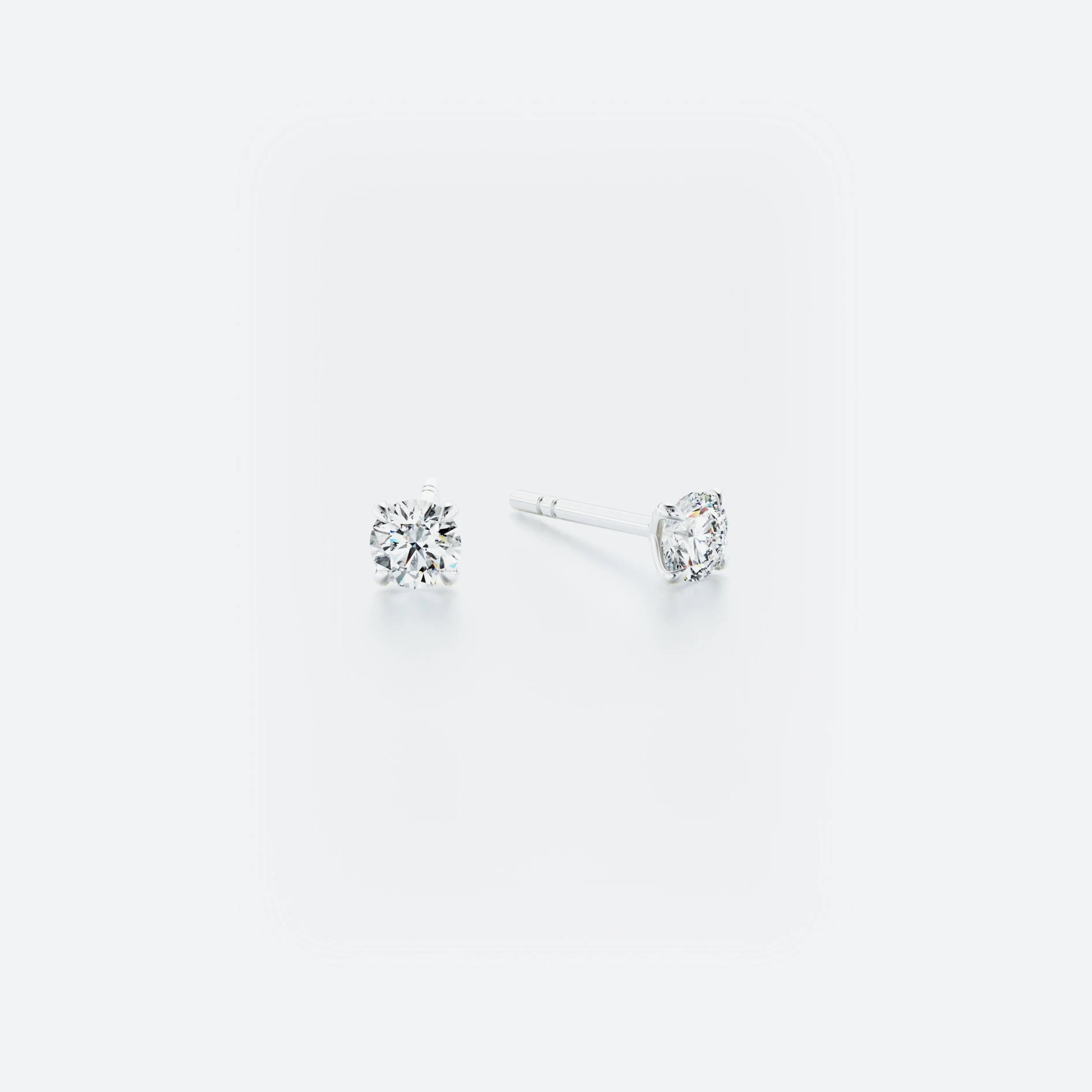 Pair of classic stud earrings crafted from 14k white gold, featuring brilliant diamonds with a total weight of 0.40 ct.