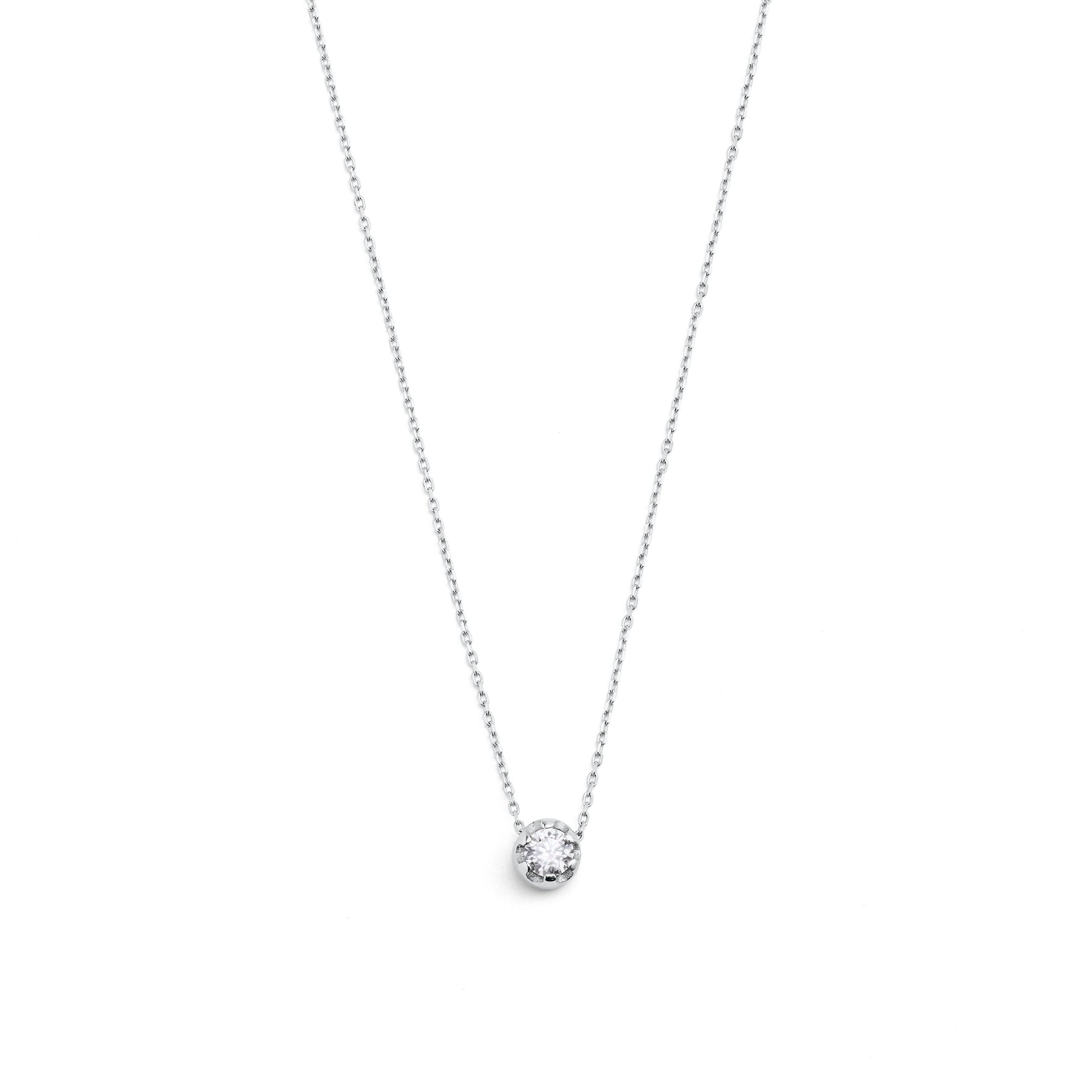 White gold pendant featuring a round brilliant-cut diamond, suspended from a delicate gold chain.