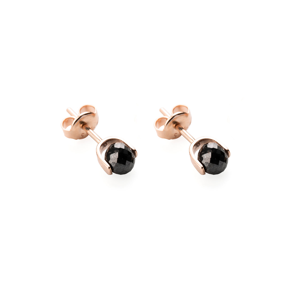 Gold earrings with black diamonds on a white background