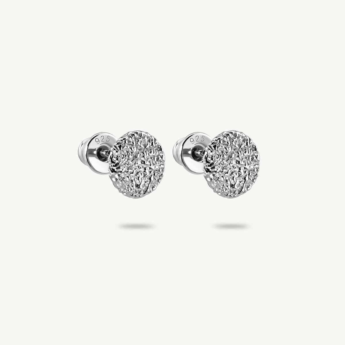 A pair of silver stud earrings, featuring a textured surface, on a clean white background.