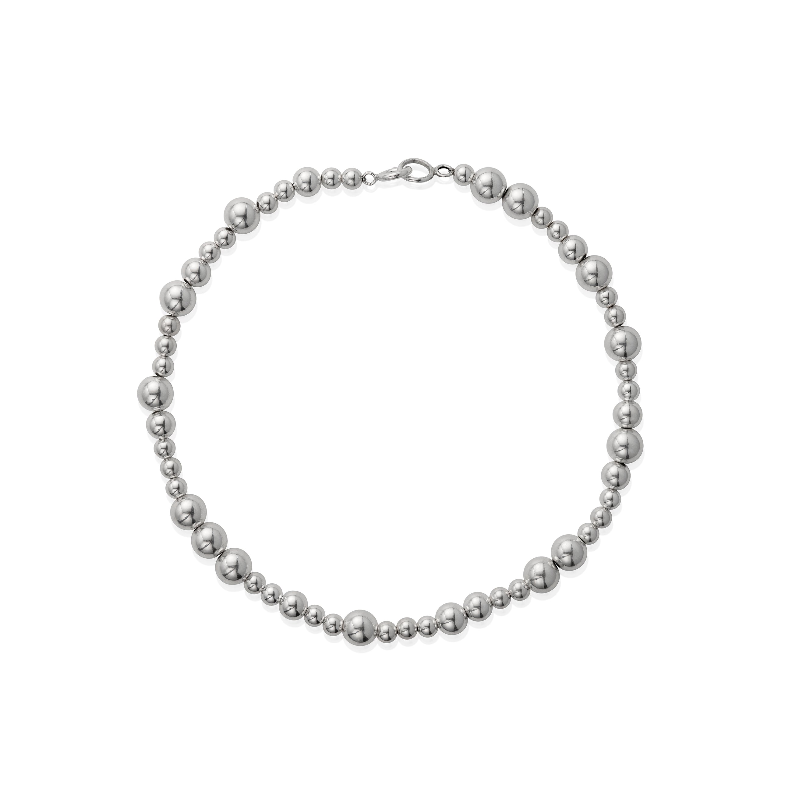 A silver necklace with varying sizes of beads, displayed against a white background.