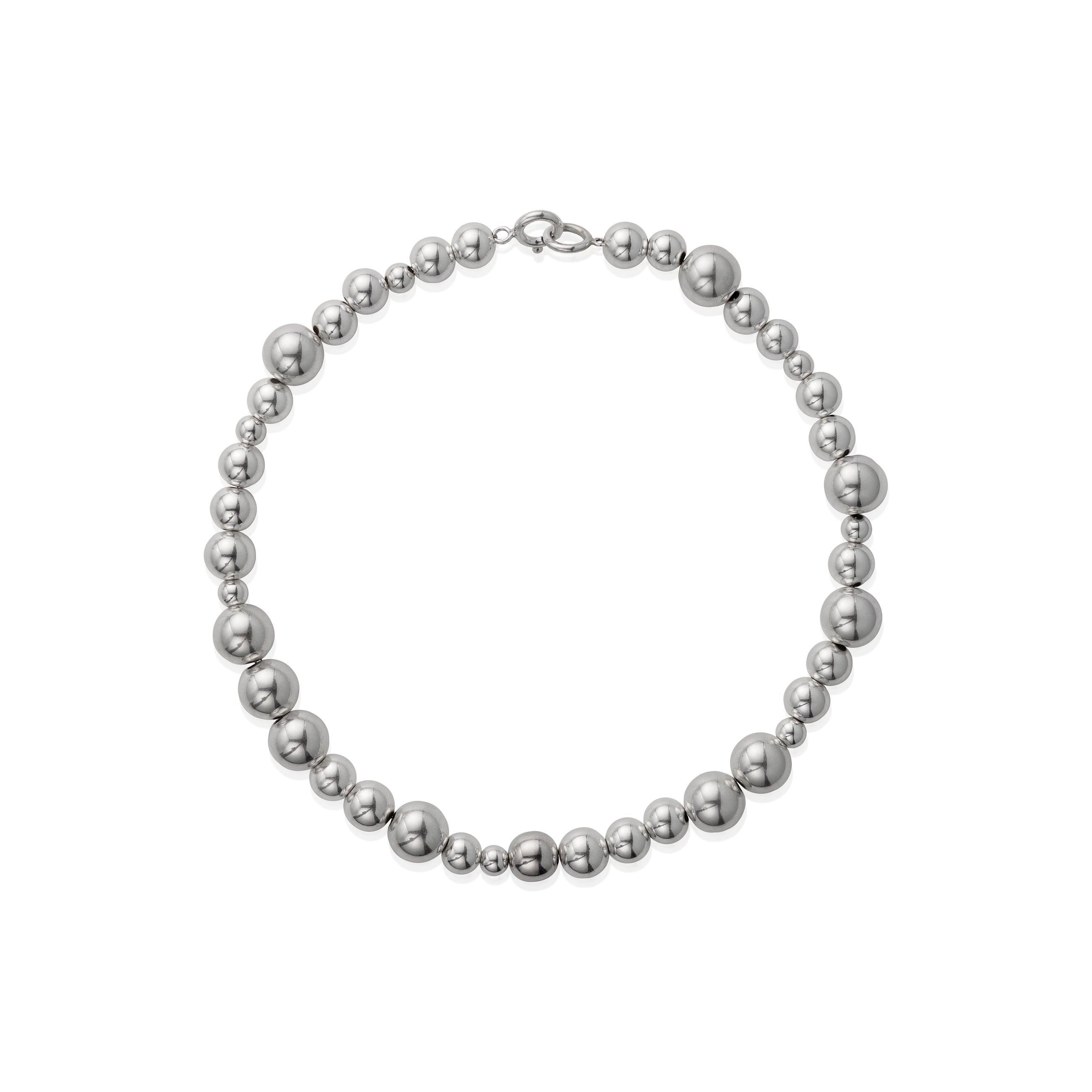 A necklace with varying sized silver beads strung together on a chain.