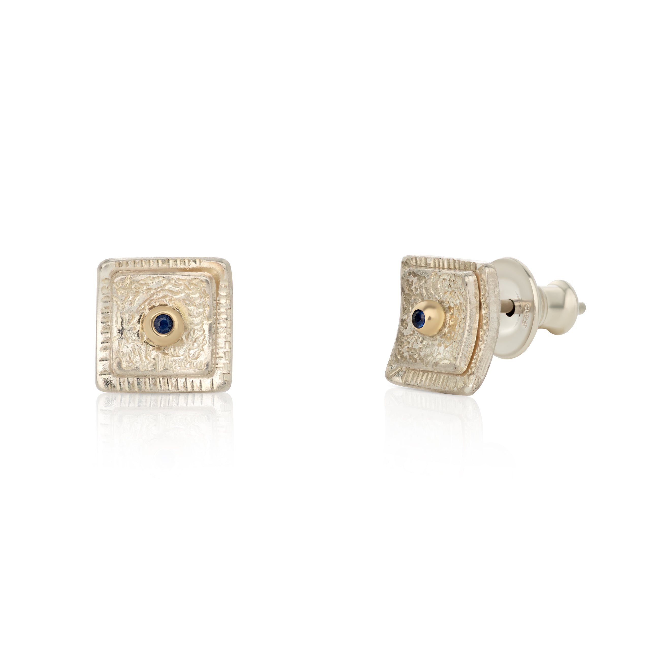 A pair of silver square-shaped earrings with blue sapphires in the center, displayed against a white background.