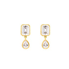 Gold earrings with emerald-cut and teardrop-shaped topaz on a white background