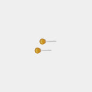 Silver stud earrings, featuring Baltic amber by Adele Notes.