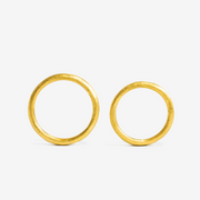 Two 24k gold hand-forged seamless ring on a white background