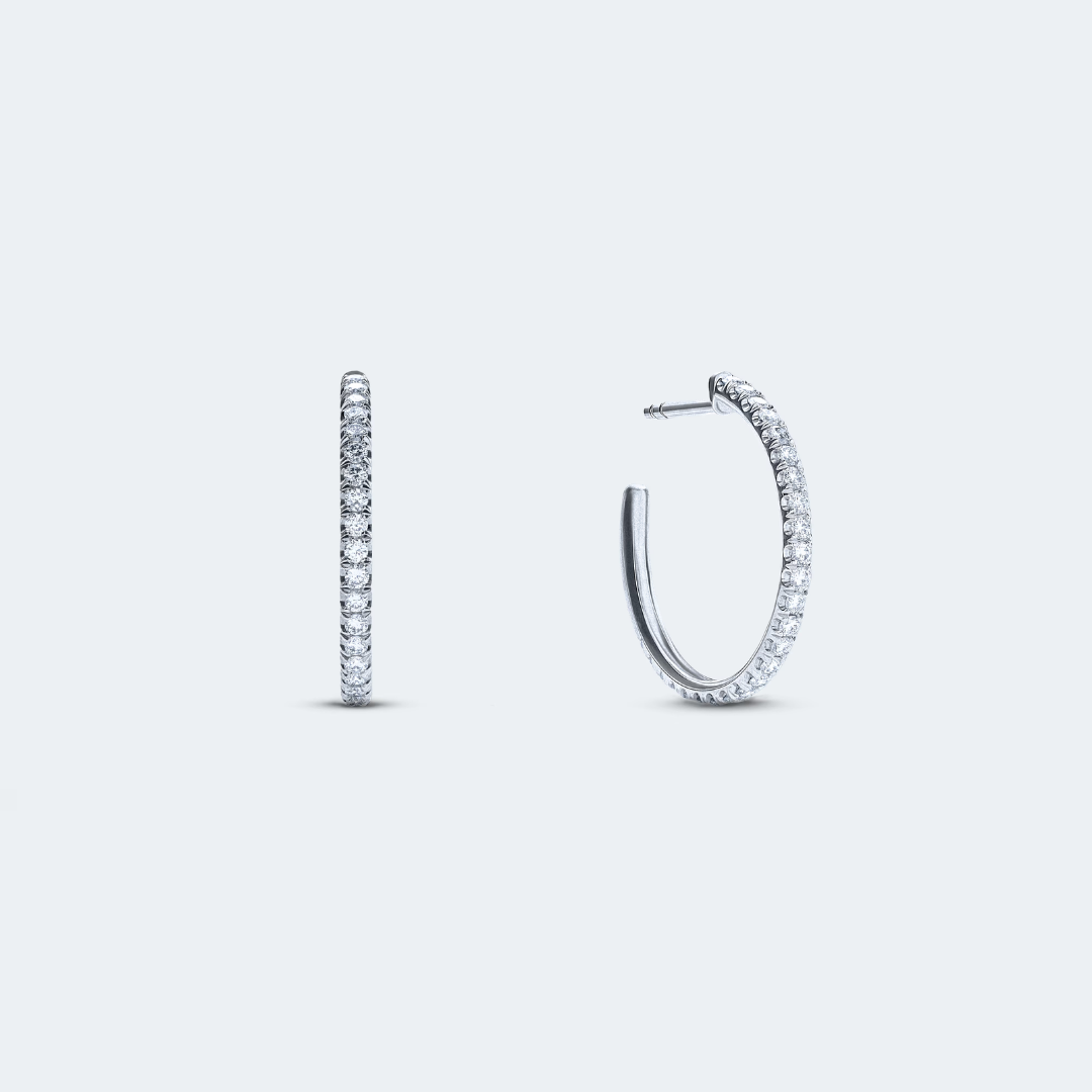 White gold hoop earrings featuring a row of pavé-set diamonds for subtle sparkle, with a total carat weight of 0.45 ct.
