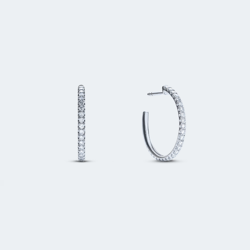 White gold hoop earrings featuring a row of pavé-set diamonds for subtle sparkle, with a total carat weight of 0.45 ct.