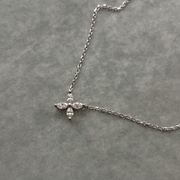 Delicate flower pendant crafted in 14k white gold, adorned with marquise-cut diamonds.