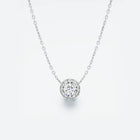White gold necklace with a round diamond pendant on a light gray background
