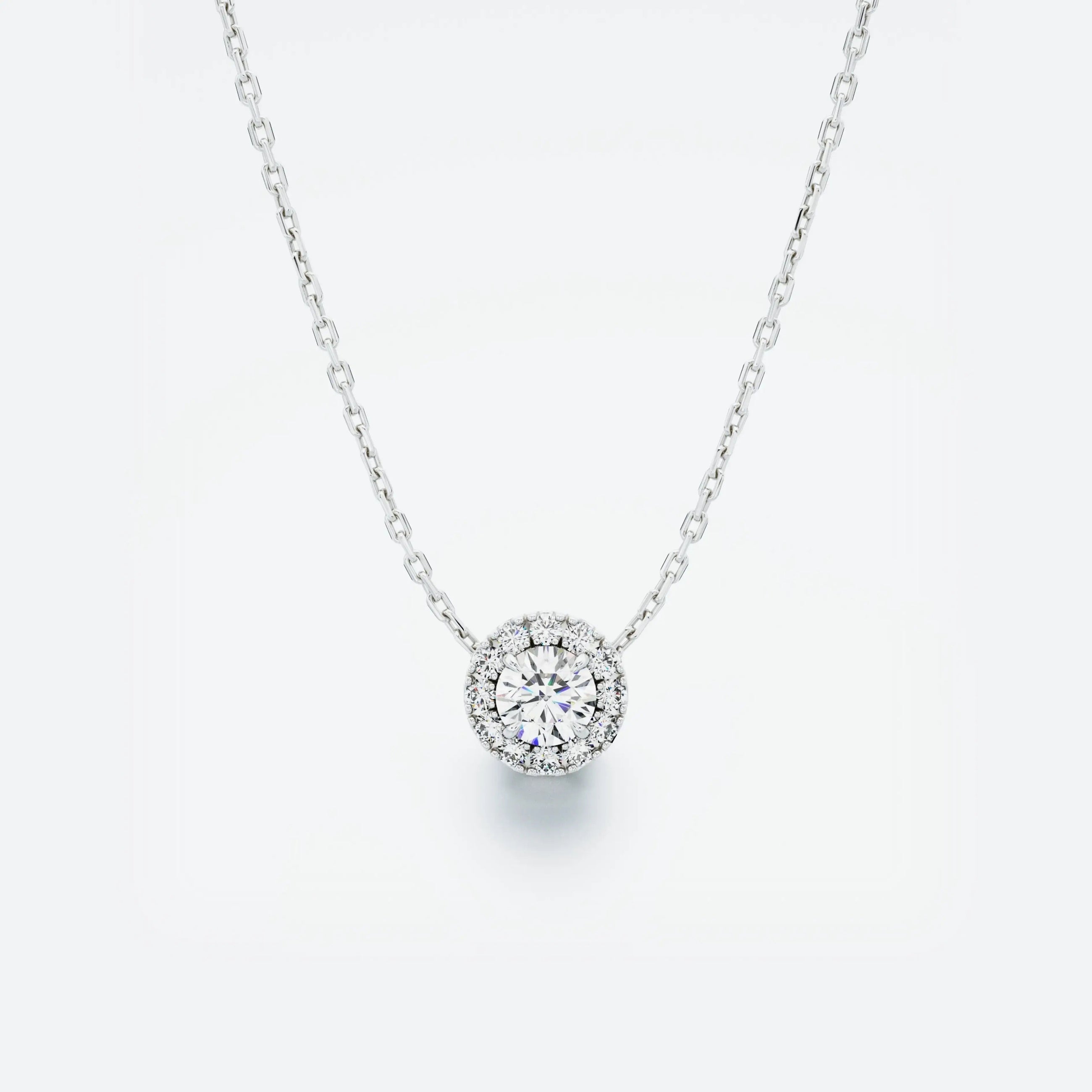 White gold necklace with a round diamond pendant on a light gray background