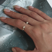 Pear-Shaped diamond hug ring featuring two pear-shaped diamonds gracefully set on an open band, with a total carat weight of 0.60 ct.