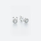 A pair of 14k white gold halo stud diamond earrings with a central diamond surrounded by a halo of pavé-set diamonds.