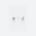 Pair of diamond stud earrings on a white background