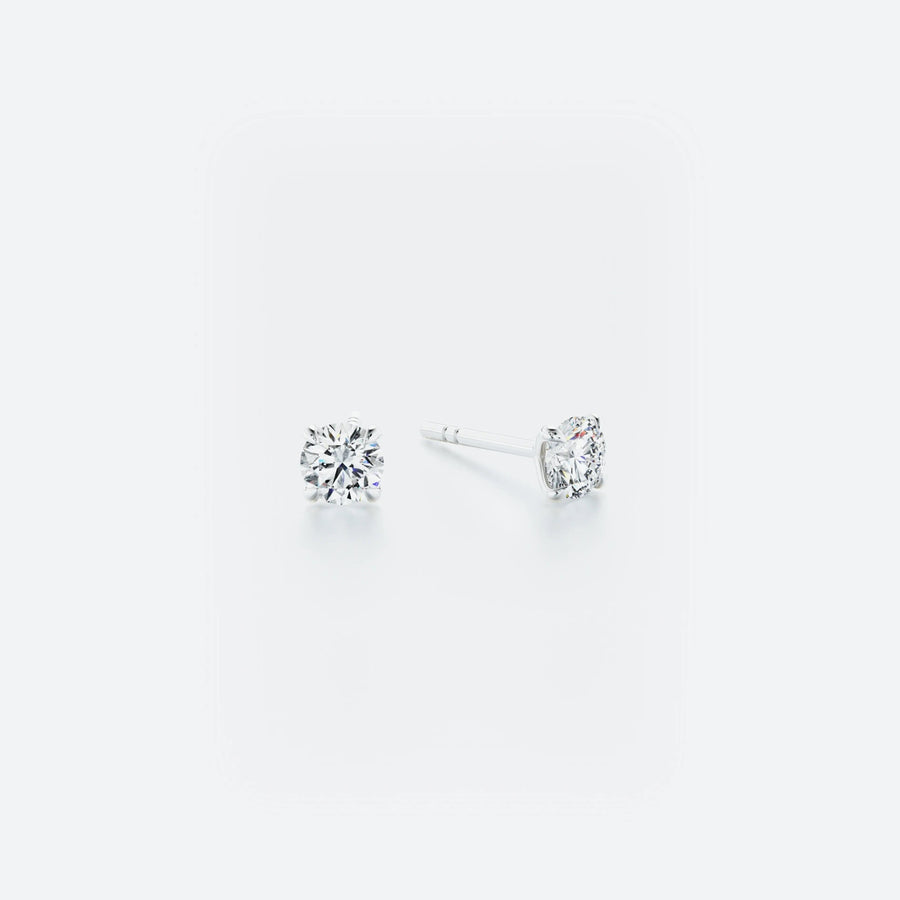 Pair of diamond stud earrings on a white background