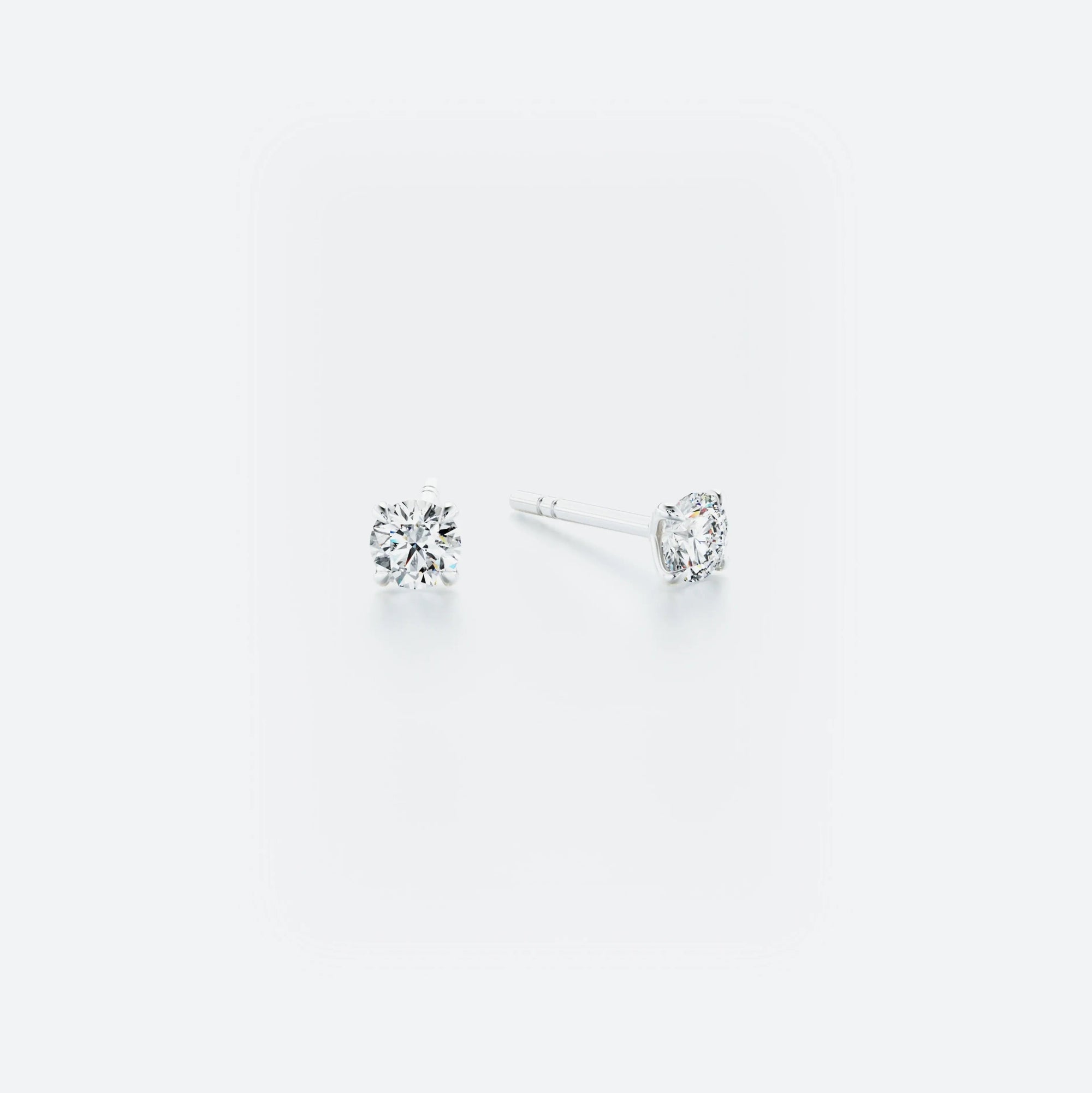 Pair of classic stud earrings crafted from 14k white gold, featuring brilliant diamonds with a total weight of 0.40 ct.