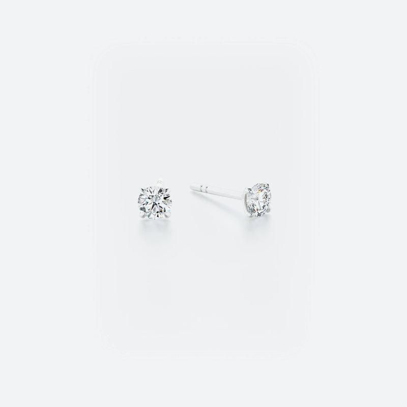 Pair of classic stud earrings crafted from 14k white gold, featuring brilliant diamonds with a total weight of 0.40 ct.