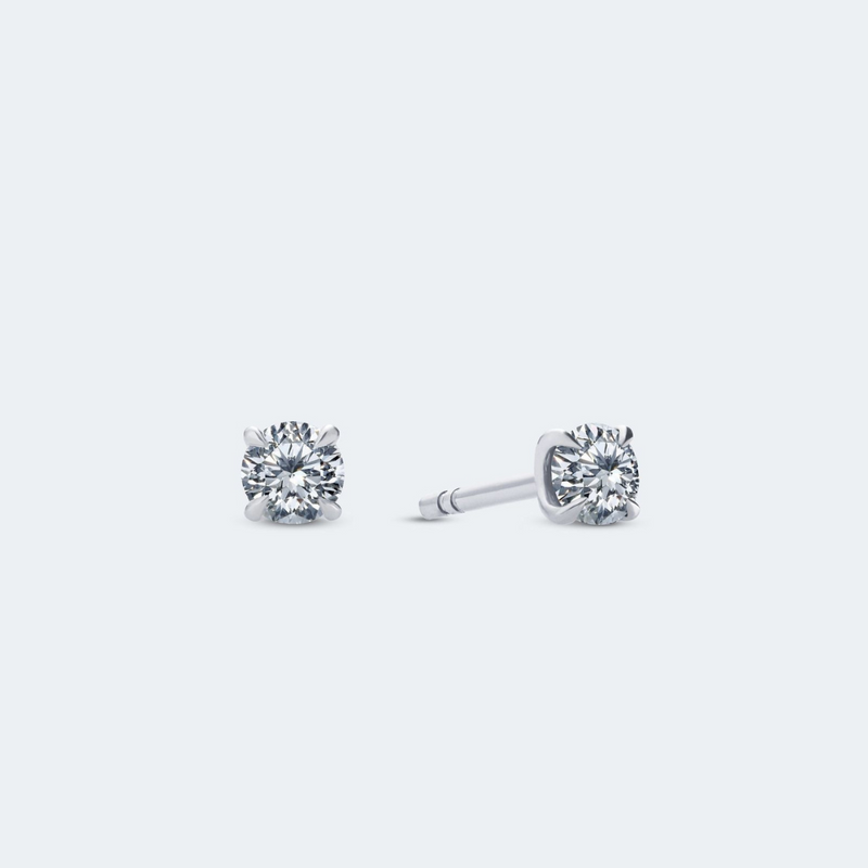 A pair of round brilliant-cut diamond stud earrings in white gold, with a total carat weight of 0.6 ct.
