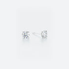 Pair of diamond stud earrings on a white background