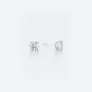 Pair of diamond stud earrings on a white background