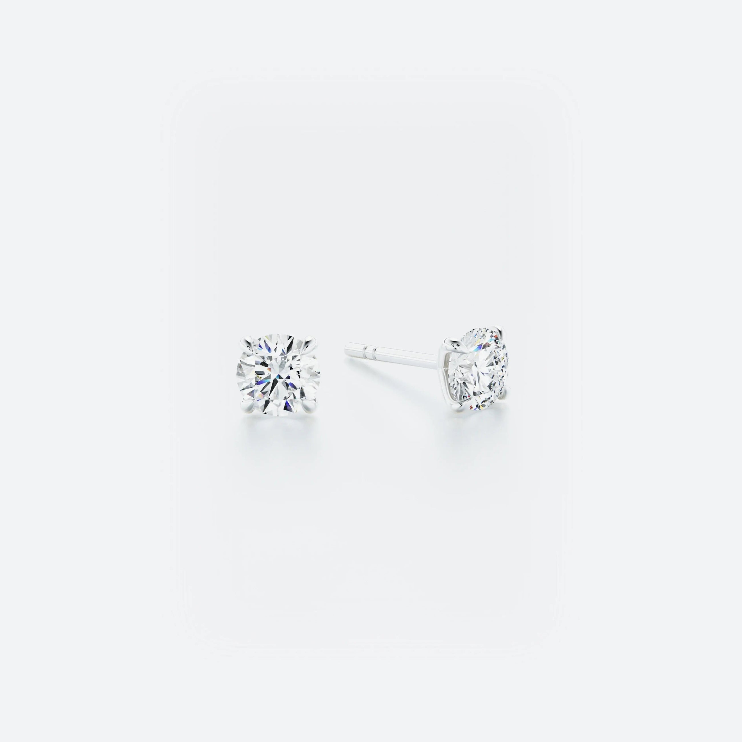 Pair of diamond stud earrings on a white background