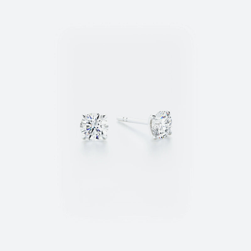 Pair of diamond stud earrings on a white background