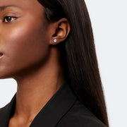 Woman wearing classic stud earrings crafted from 14k white gold, featuring brilliant diamonds with a total weight of 1.00 ct. 