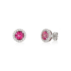 A pair of 14k white gold halo stud earrings featuring round pink topaz centers surrounded by a row of round brilliant-cut lab-grown diamonds, with push-back closures.
