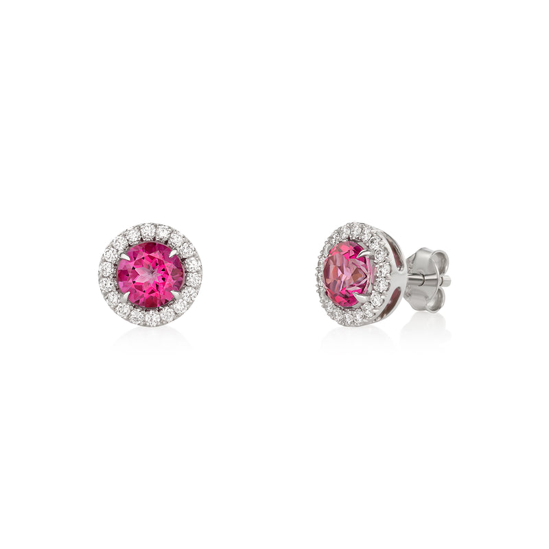 A pair of 14k white gold halo stud earrings featuring round pink topaz centers surrounded by a row of round brilliant-cut lab-grown diamonds, with push-back closures.