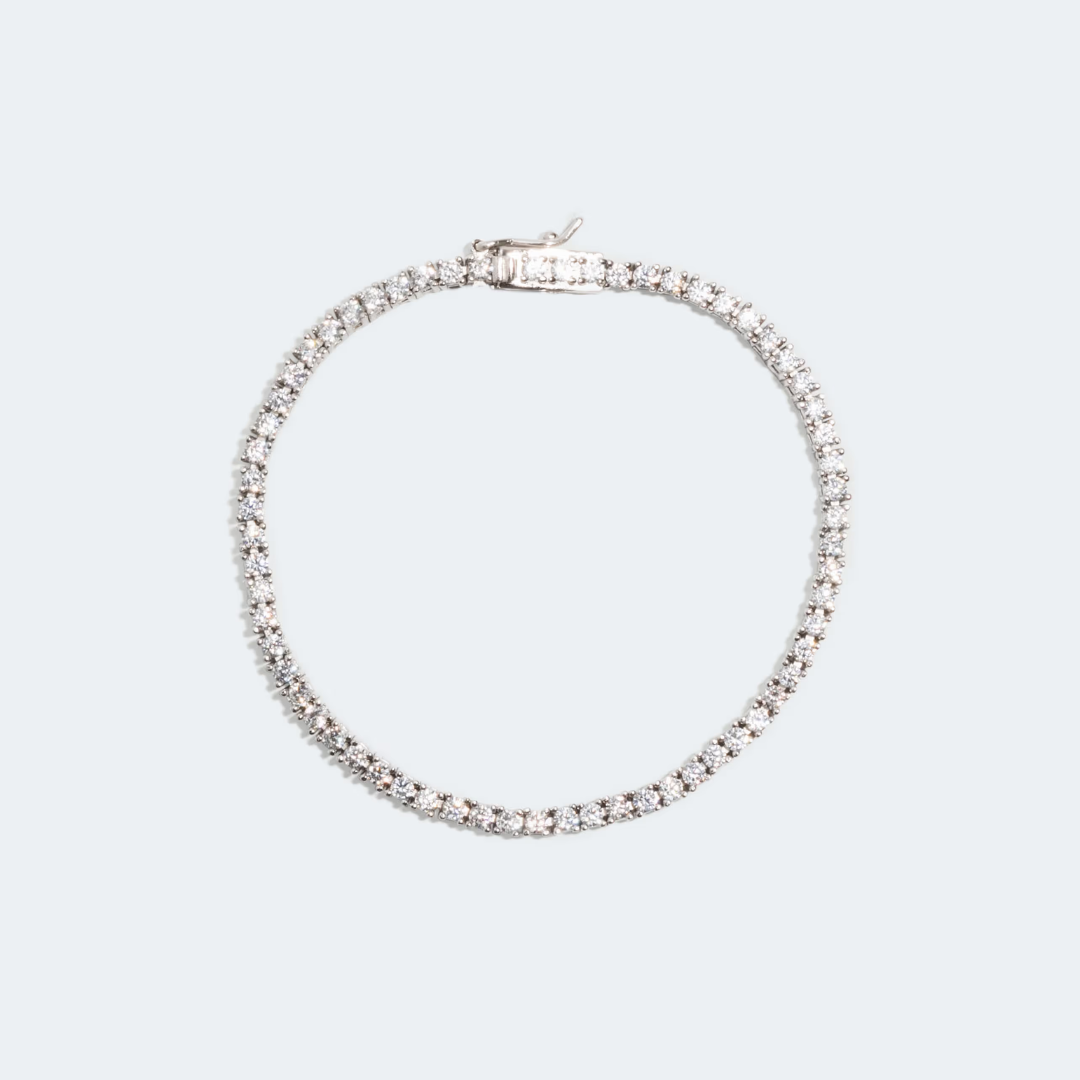 Tennis bracelet created in 14k white gold, featuring a seamless row of brilliant diamonds set along the entire band for a continuous sparkle. 