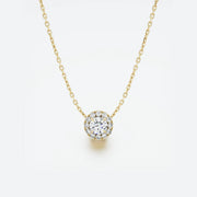 Yellow gold necklace with a round diamond pendant on a light gray background