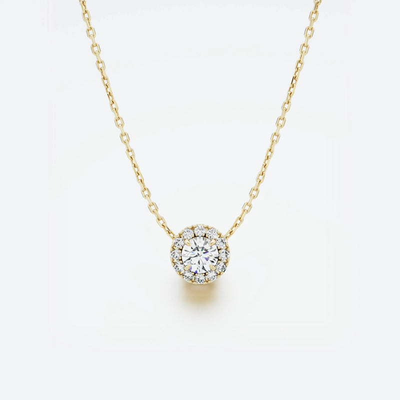 Yellow gold necklace with a round diamond pendant on a light gray background