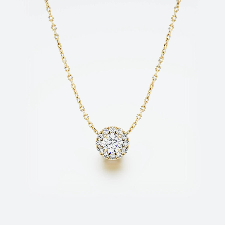 Yellow gold necklace with a round diamond pendant on a light gray background