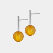 earrings, featuring a structured band and a bold Baltic amber element.