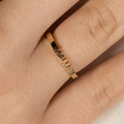 Gold ring with 'MAMA' engraving on a finger