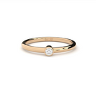 An engagement ring with a single laboratory-made diamond set in a rose gold band