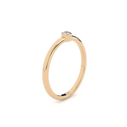 An engagement ring with a single laboratory-made diamond set in a rose gold band
