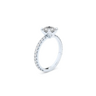 A white gold ring with a large central diamond surrounded by smaller diamonds around the band.