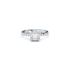 A white gold ring with a large central diamond surrounded by smaller diamonds around the band.