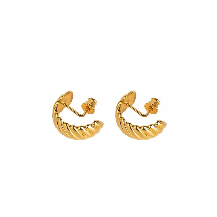 A pair of gold-plated silver huggie hoop earrings featuring a twisted design, shown on a plain white background.