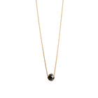 A delicate gold necklace with a faceted diamond pendant, displayed on a clean white background.