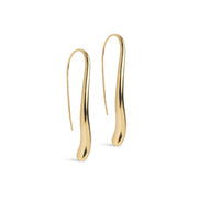 A pair of gold-colored, sculptural drop earrings with a smooth, organic wavy silhouette, displayed on a clean white background.
