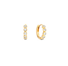 A pair of small gold-plated silver huggie hoop earrings, shown from the side and back, each adorned with five clear round-cut topaz gemstones in a bezel setting, on a solid white background.