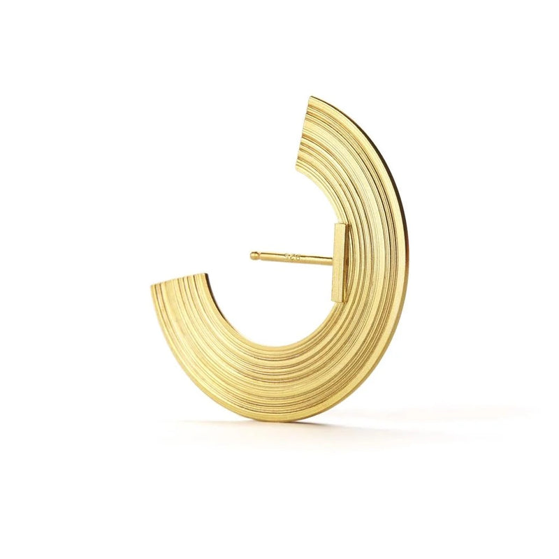 A single gold crescent-shaped hoop earring with concentric grooved detailing, shown on a clean white background.