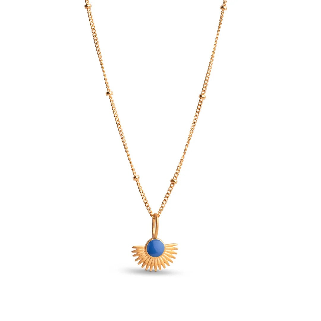 Gold necklace with a blue pendant on a white background
