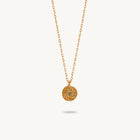Gold-plated silver chain necklace featuring a round, textured disc pendant with a small green sapphire set in the center.