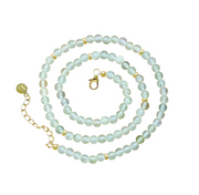 A beaded necklace featuring pale greenish-blue round prehnite stones separated by small gold-plated spacer beads, with a gold lobster clasp and extension chain on a plain white background.