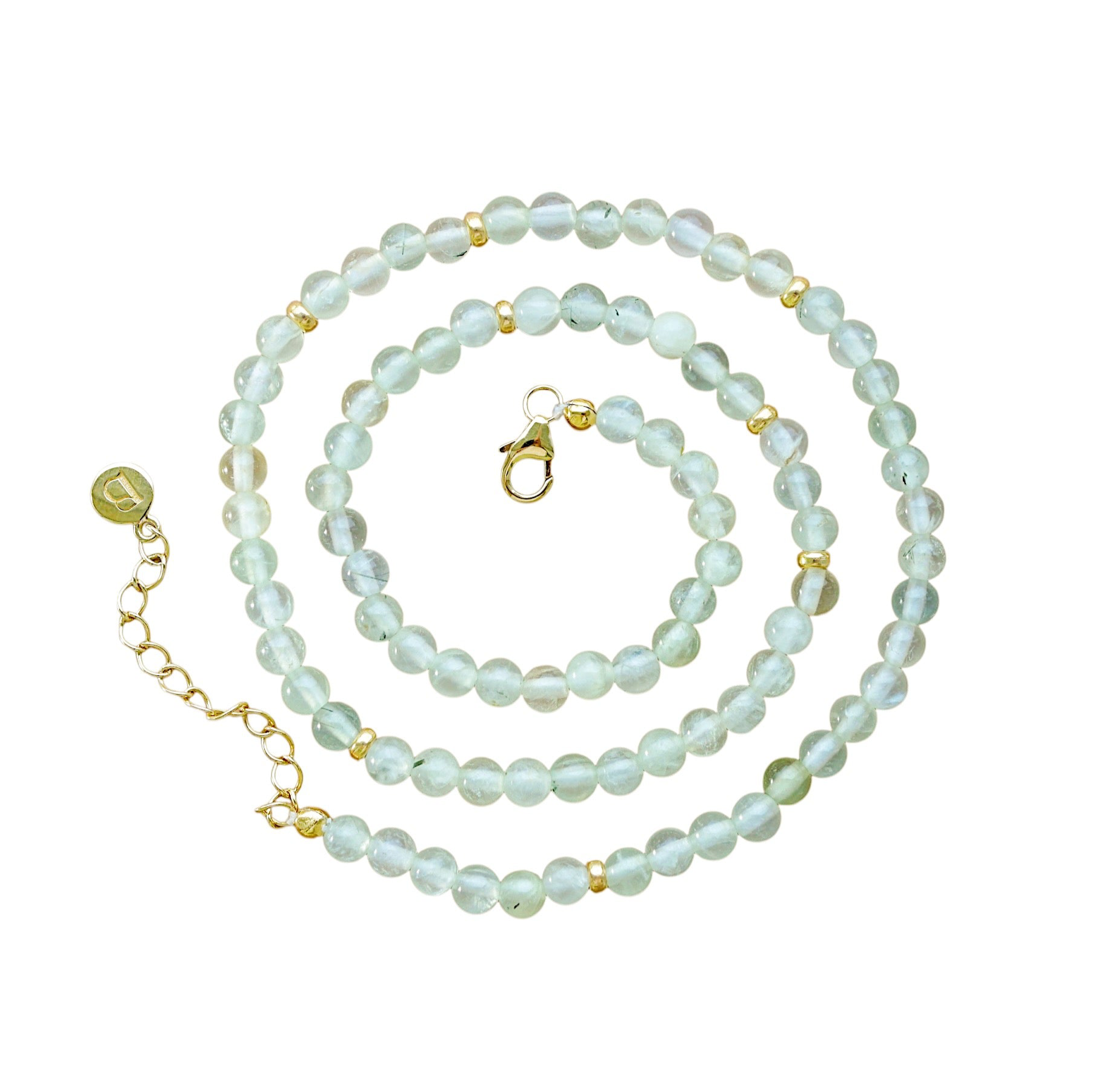 A beaded necklace featuring pale greenish-blue round prehnite stones separated by small gold-plated spacer beads, with a gold lobster clasp and extension chain on a plain white background.