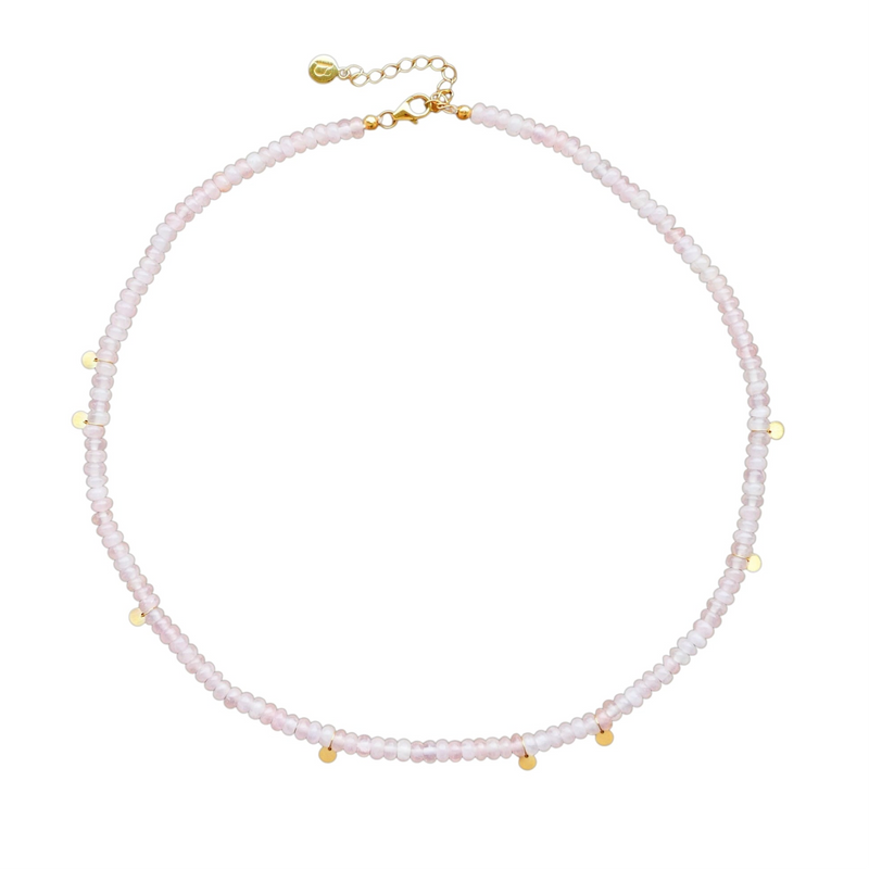 A delicate beaded necklace in pale pink quartz with small gold-plated silver accents and a gold-plated chain extender clasp, shown on a plain white background.